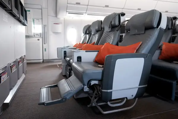 Airline premium economy seat with reclined footrest