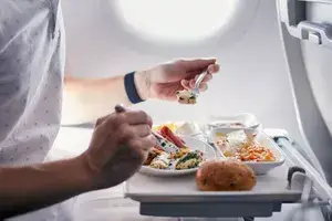 a man eating an airplane meal 