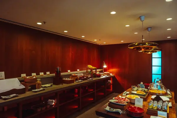 Buffet setup with various food items in a lounge setting