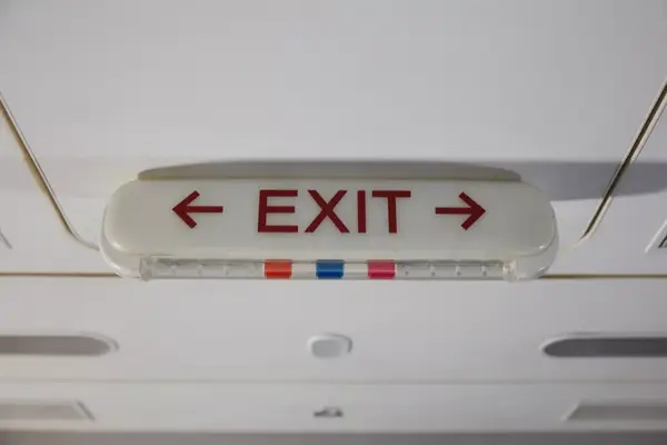 Exit sign on the ceiling with arrows pointing left and right