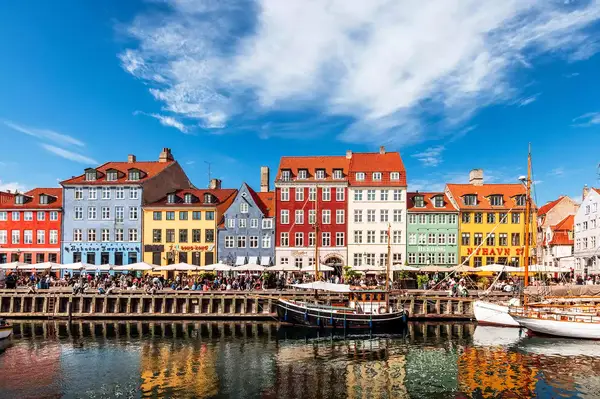 Colorful buildings in a waterfront location with boats docked near a canal