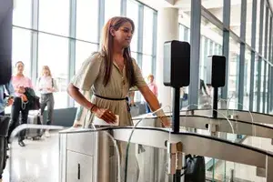 A person at an airport facial recognition checkpoint scanning their face