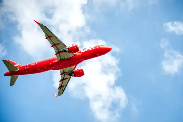 Play Airlines plane flying in the blue sky above