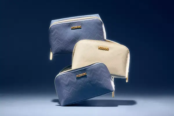 Three amenity pouches by Missoni in a staged arrangement on a dark background