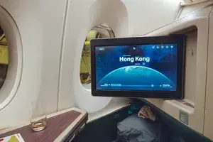 Airplane cabin interior with a screen displaying 