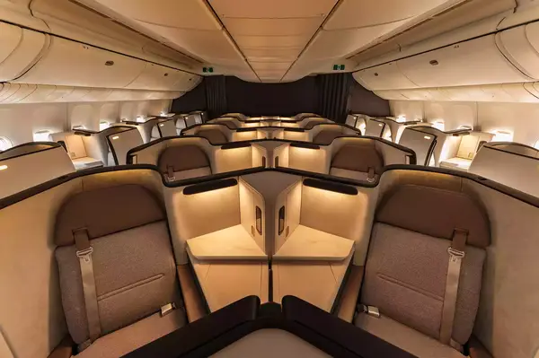 Business class seats arranged in a luxurious layout in an airplane cabin