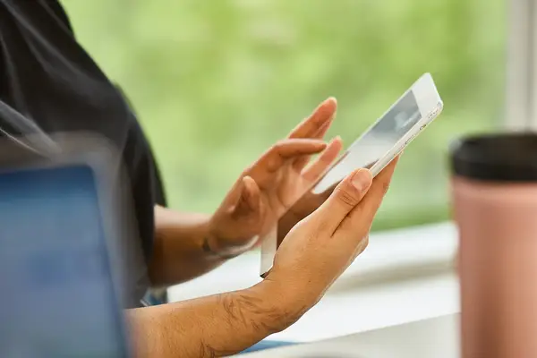 Person using a smartphone, focused on the screen and interacting with it
