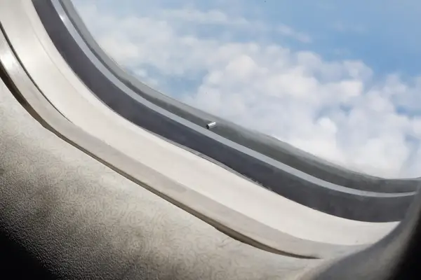 View of aircraft window and sky outside