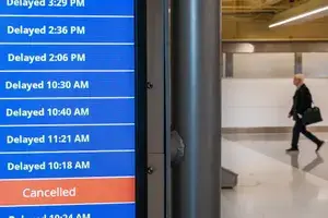 Cancelled and delayed flights on a departure board at Ronald Reagan National Airport
