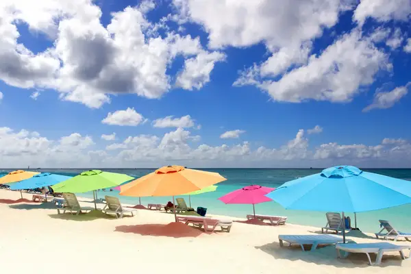Beach with colorful umbrellas and lounge chairs by the ocean