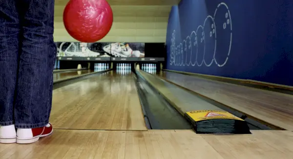 bowler holding a pink ball