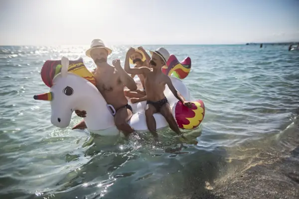 funny father ands sons all wearing giant moustaches playing at sea nikon d850