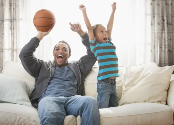 a person and a boy playing basketball