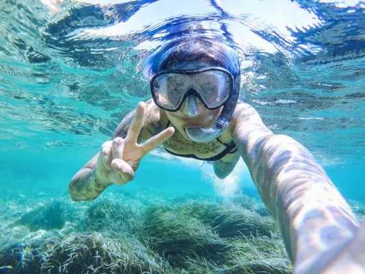 Young woman swimming with mask snorkeling