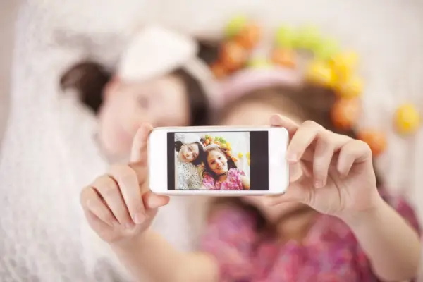 two girls taking selfie with easter eggs