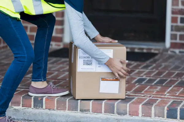 unrecognizable delivery person picking up or dropping off package