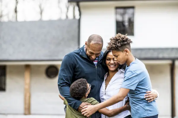 portrait of family in front of residential home