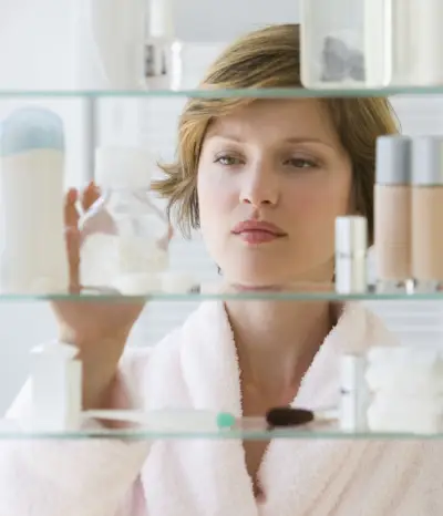 woman looking in medicine cabinet