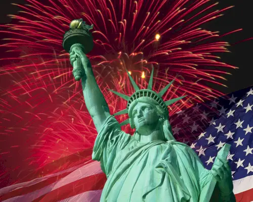 the statue of liberty in front of the united states stars and stripes flag and fireworks