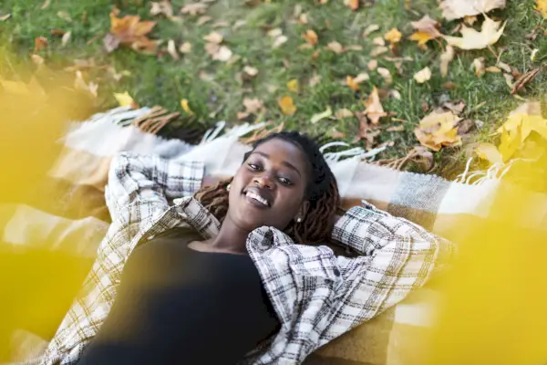 black couple walking together in park in autumn