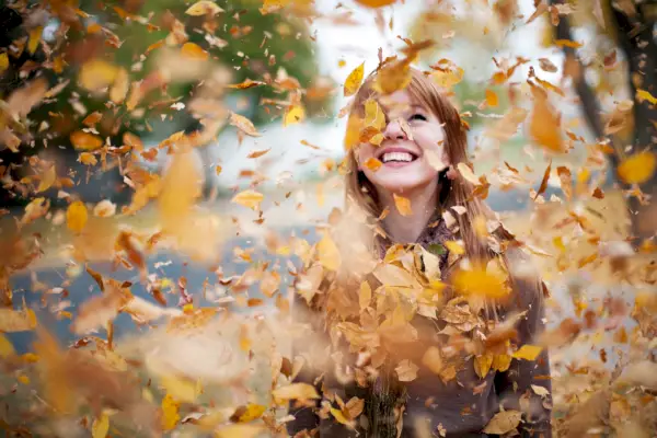 Redheaded Girl in Cloud of Leaves