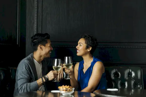 couple toasting wine glasses at restaurant