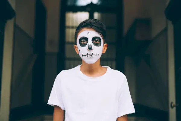 diy skeleton costume on boy in pumpkin patch