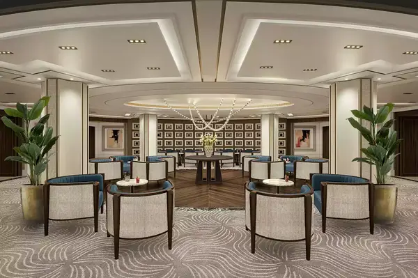 A luxury lounge area with seating and decorative lighting, featuring framed artwork and potted plants