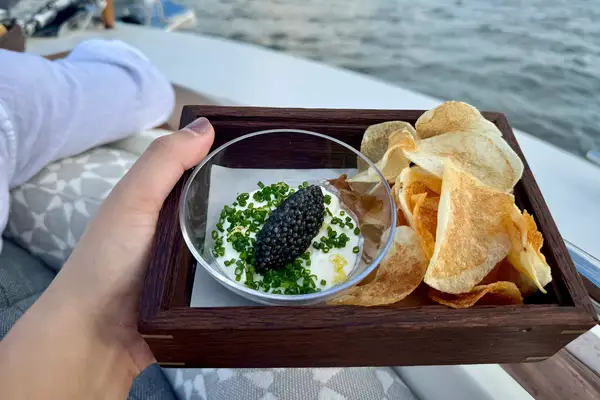 A tray of chips and caviar on the Aman New York Yacht 