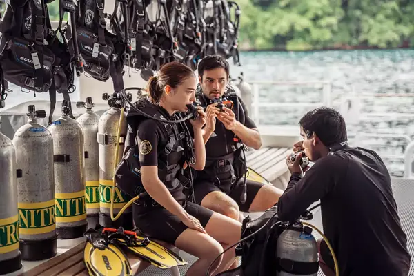 A couple preparing to scuba dive.
