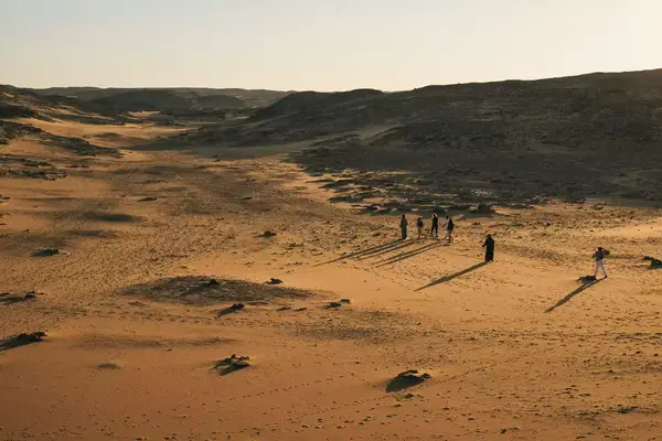 Tourists walking in a desert in Egypt