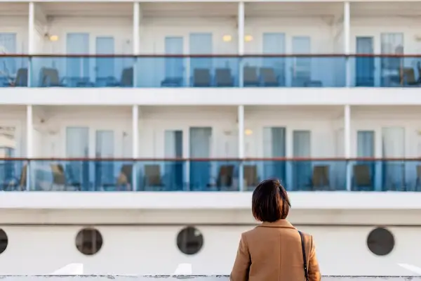 Woman looking up at a cruise ship