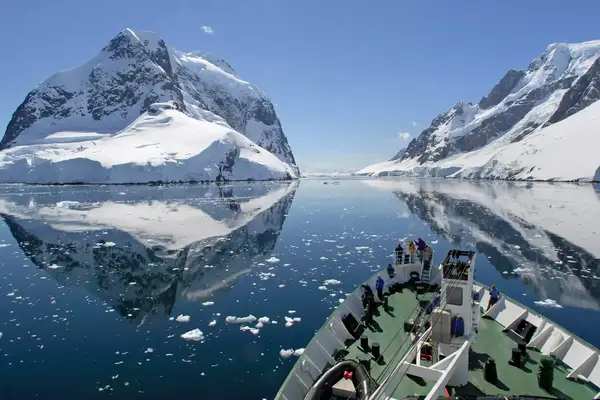 A small cruise ship makes passage through the Lemaire Channel in Antarctica