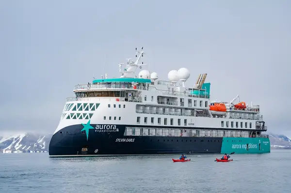 Kayakers paddling near the Sylvia Earle in Samarinbreen, Svalbard