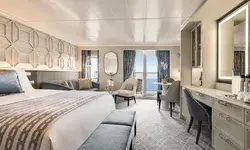 Luxurious penthouse suite with a bed sitting area balcony and desk