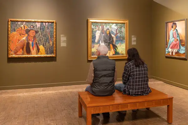 Two people look at art at the Albuquerque Museum in New Mexico