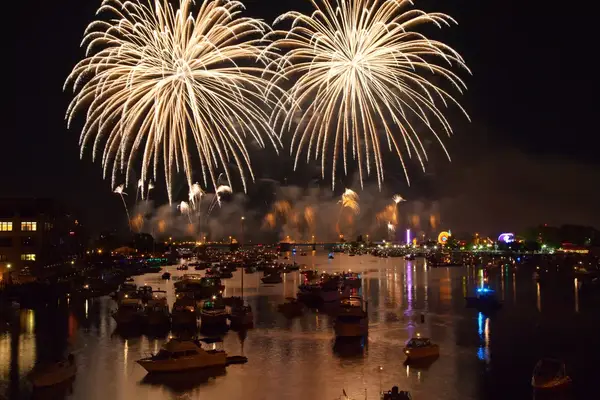 Fireworks explode over boats on the Saginaw River in Michigan