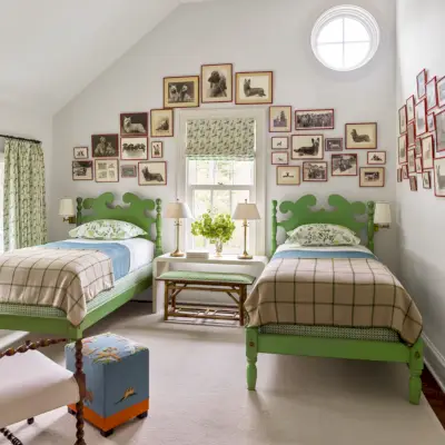 bedroom with green twin beds and gallery wall of dog pictures