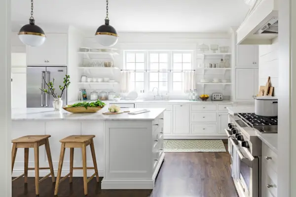 light and bright farmhouse kitchen with black and brass orb light fixtures