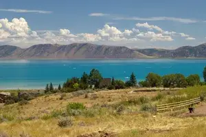 A landscape showing Bear Lake surrounded by mountains and vegetation