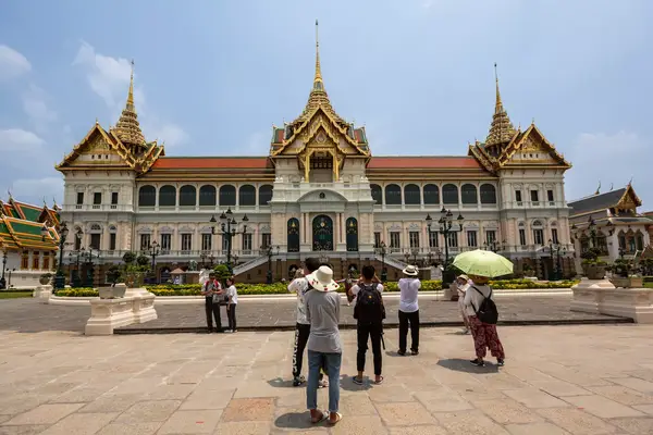 People standing outside of the grand palace