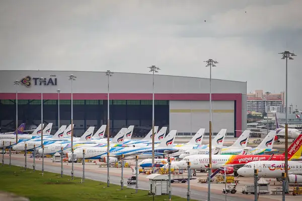 A line of plane outside of an airport
