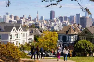 People walk on a path near homes in San Francisco