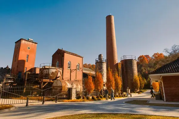 Exterior of the Castle & Key Distillery, will fall foliage and blue skies