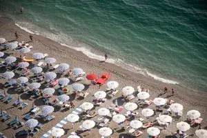  Umbrellas and sunbeds at the free beach of the bay between Salerno and Vietri sul Mare