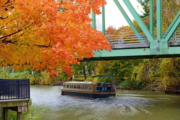 A canal boat on the Erie Canal near Rochester, New York, framed by fall foliage