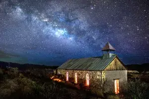 Predawn in Terlingua, TX the Milky Way rises to the SE. This rarely used church in the ghost town was a perfect subject. I put 3 headlamps on the pews to light the windows and light painted the exterior.