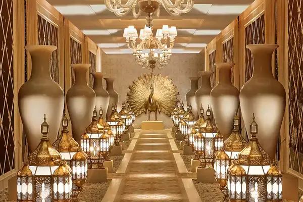 A hallway in The Spa at Encore Las Vegas adorned with golden vases, lanterns, and a peacock sculpture