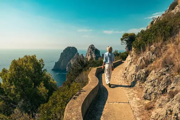 A woman walks on a path in Capri