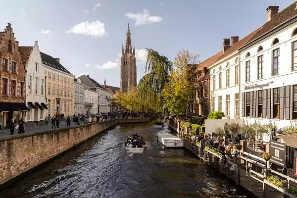 People walk along the canals in Bruges.